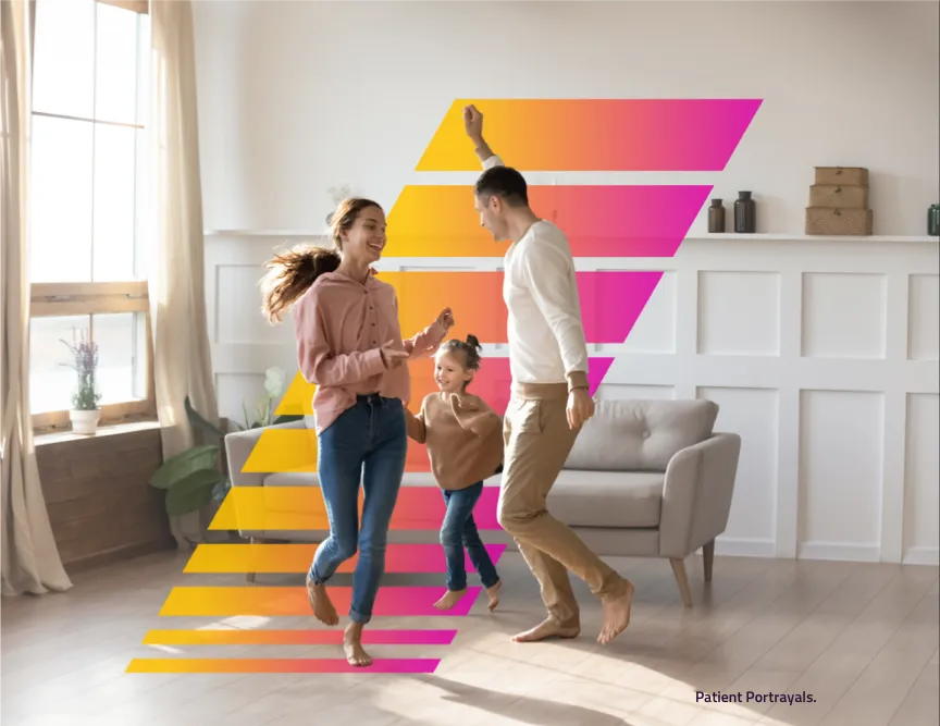 Two adults and a child dancing.